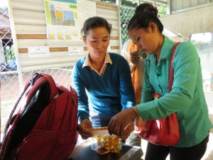 Clear Cambodia's Battambang staff test open well water with the CBT