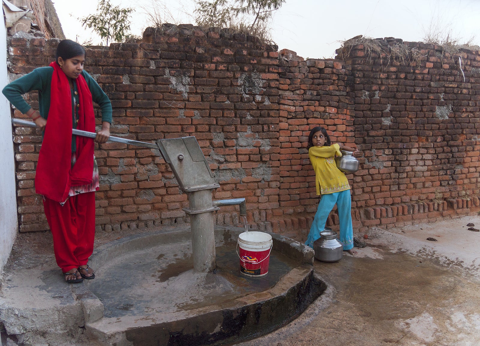 Pumping The Last Pots Of Water From Communal Pump In T